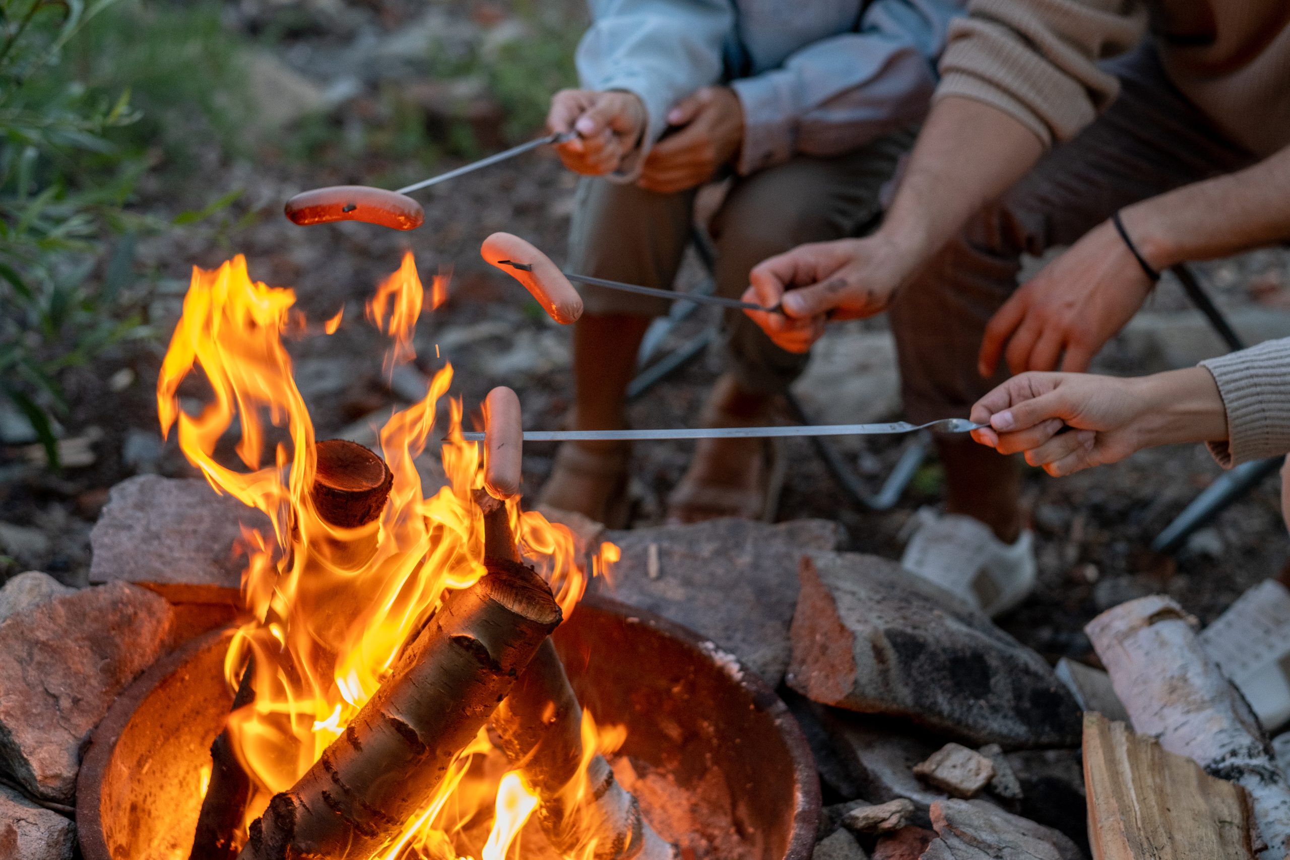 cooking hotdogs over fire in nc while yurt camping