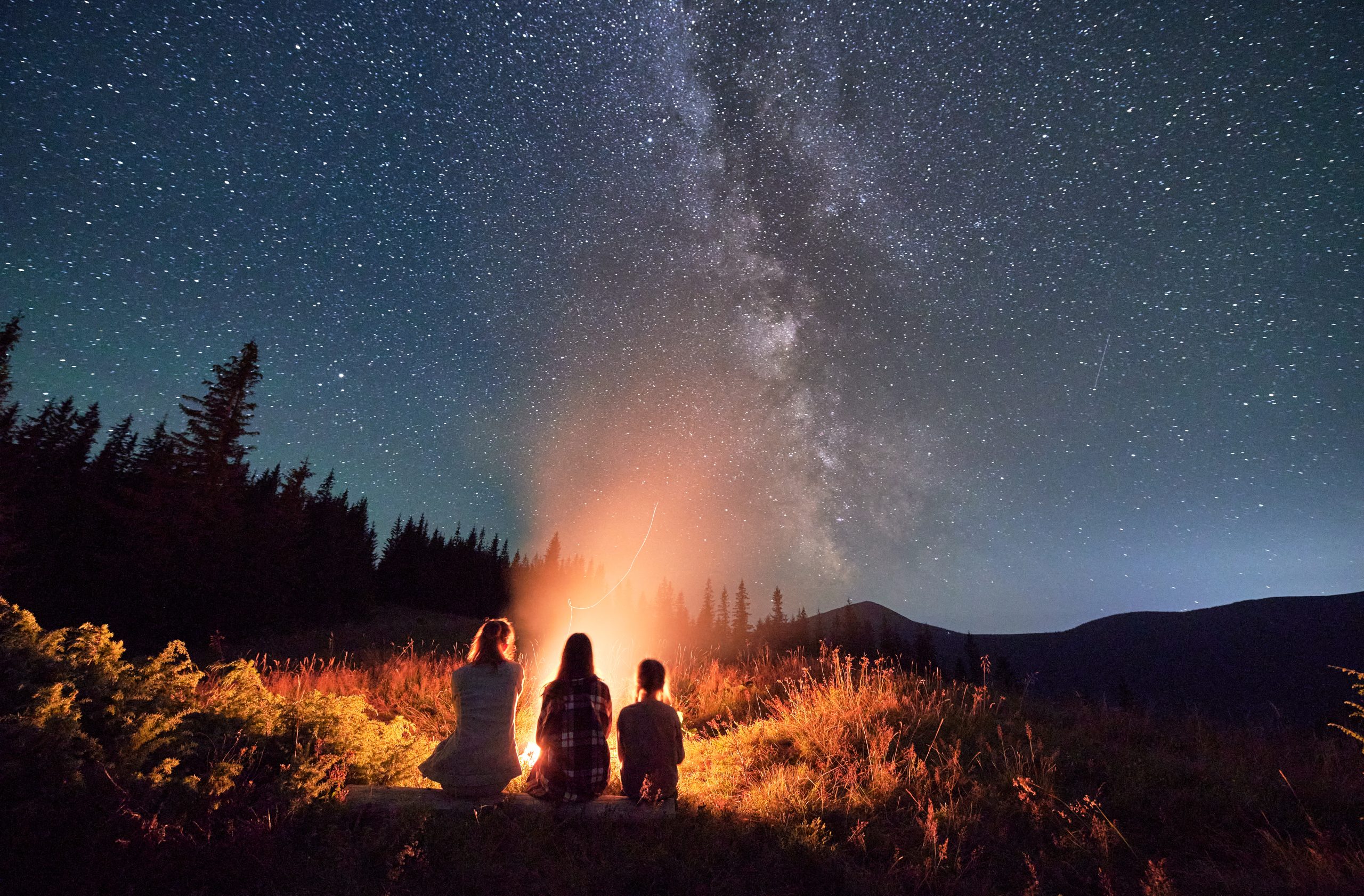 family watching the stars in nc while yurt camping