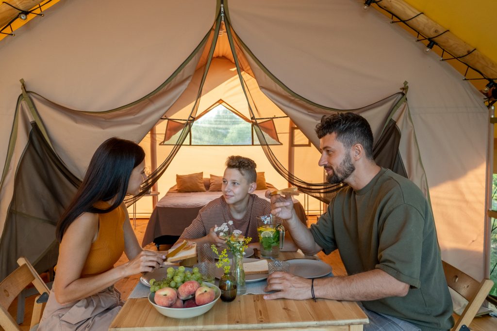 family eating breakfast in a safari tent on a north carolina glamping site
